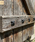 Close-up of Colonial Era Solid Cast Iron Decorative Nailhead Studs For Doors, Cabinets And Furniture in rustic setting