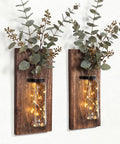 Game Changer Rustic Two Pack Wood Glass Wall Sconces Paired With Warm Twinkle Lights showing vases with greenery and lights.