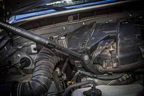 29 To 48 Inch Extendable Pry Bar With 180 Degree Rotating Head Featuring 14 Locking Positions used in a car engine compartment