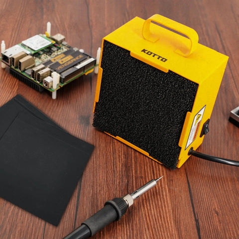 Dual Activated Carbon Filter Solder Fume Extractor With Slick Removable Magnetic Flaps And Steady Airflow on wooden surface.
