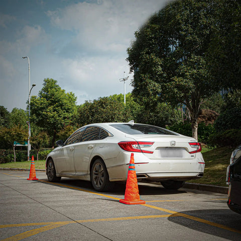Car parked next to Four Pack 28 Inch Collapsible LED Light Traffic Cones With Reflective Safety Pop Up Design Battery Included