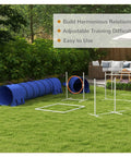 Blue 7 Piece Dog Agility Training Set For Backyard Fun with weave poles, tunnels, hurdles, jump ring, and pause box on grass