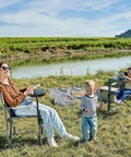 People outdoors using Heavy Duty 300 Lb Folding Director Chair With 2 Way Rotating Side Table, cup holder, and ergonomic mesh back