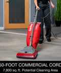 Hardcore Commercial Upright Bagged Vacuum Cleaner With Vibra Groomer Brush Roll in use on a carpet with 50-foot power cord.