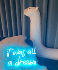 Blue USB Neon Sign for Wall Decor It Was All a Dream LED Neon Light next to plush alpaca and fur throw in living room.