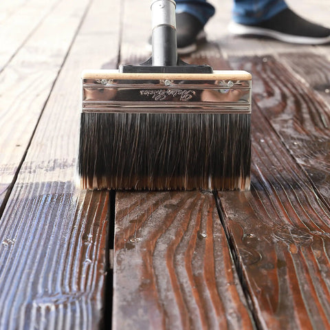 Deck Stain Brush 7.5 Inch Wood Stain Applicator With Premium Synthetic Bristles applying stain on wooden deck surface