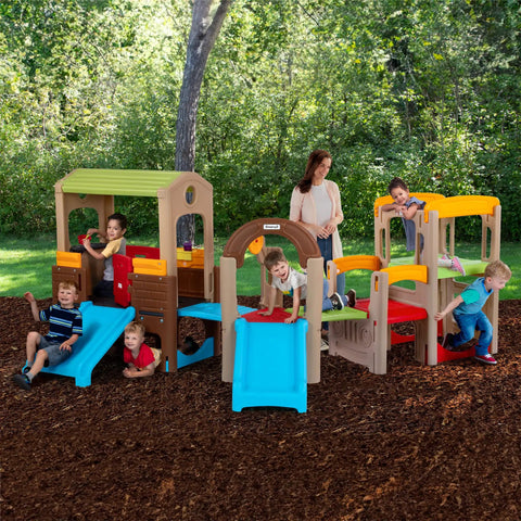 Children playing on Young Explorers Modular Outdoor Playset For Kids Ages 18 Months To 6 Years with slide and playhouse