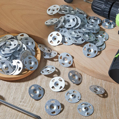 Snag This Pro Grade Bulk Pack Of 2000 Galvanized Steel Washers Sized At 1-1/8 Inches, scattered on a wooden surface with a drill.