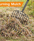 Wide Head Pitch Fork For Manure And Hay, Beefy Heavy Duty 14.96 Inch Head With 10 Tines turning mulch in grassy field.