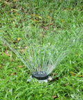 Nine Pattern Turret Lawn Sprinkler With Heavy Duty Metal Base on grass, adjustable coverage for small to medium yards and irregular lawns