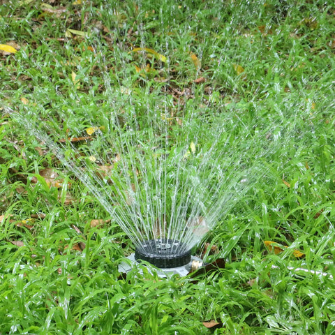 Nine Pattern Turret Lawn Sprinkler With Heavy Duty Metal Base on grass, adjustable coverage for small to medium yards and irregular lawns