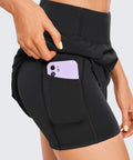Close-up of black High Waisted A Line Golf Skirt With Built In Short Ultra Soft Quick Dry Fabric featuring pocket with phone.