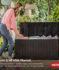 71 Gallon Outdoor Resin Storage Box for Patio Cushions and Throw Pillows, open lid, all-weather brown chest on grass.