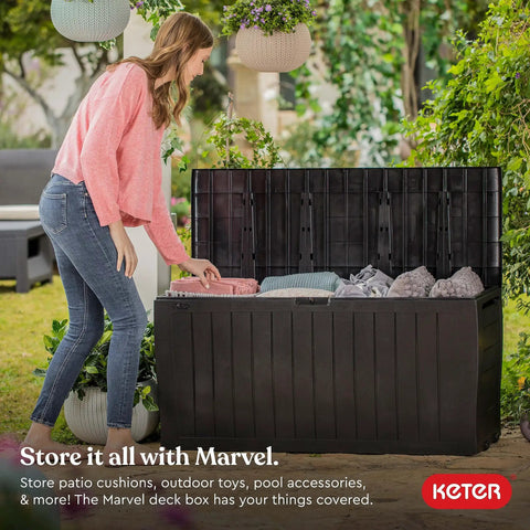 71 Gallon Outdoor Resin Storage Box for Patio Cushions and Throw Pillows, open lid, all-weather brown chest on grass.