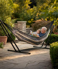 XXL Handwoven Mayan Double Hammock For Outdoor Use With Thick Cord 156 Inch Wide 90 Inch Deep And 625 Pound Capacity Heavy Duty Outdoor Hammock In Black And Natural, two people relaxing on patio