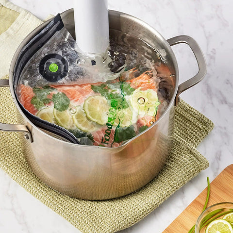 Reusable Quart Vacuum Zipper Bags, 10 Count, BPA Free, Microwave Safe, Leakproof filled with salmon and herbs in sous vide pot
