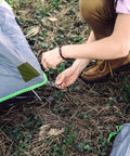Person applying Nylon Repair Tape For Tents And Gear Durable Waterproof Flexible Patches For Fabric Repairs Fast Fix No Glue Or Heat to tent.