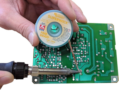 Desoldering Solder Wick No Clean Fine Braid With RMA Flux Pro Grade Copper Solder Wick 5 Ft Length 0.075 Inch Width in use on PCB