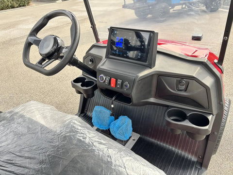 Interior view of Red 48 Volt 105 Ah Lithium Electric Golf Cart With Spacious Built In Insulated Cooler, featuring steering wheel and display.