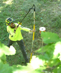 Pro Grade Arborist Throw Line Launcher Starter Kit in use, dual poles and ground base, launching through canopy, green foliage shown