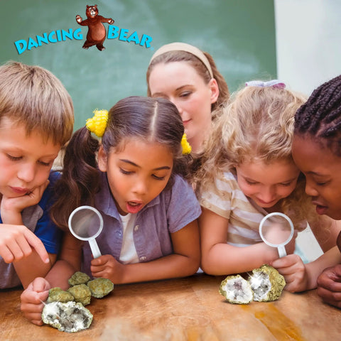 Children observing break your own Moroccan geodes with crystals inside a hands on fun science kit for kids, using magnifying glasses.