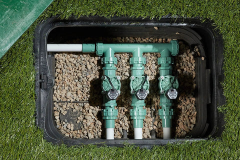 Heavy Duty 3 Valve Preassembled Irrigation Manifold With Swivel Unions installed underground in a garden setting