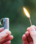 Relightable Permanent Fire Starter Metal Kit 2 Pack, waterproof emergency keychain lighter striker igniting flame outdoors.