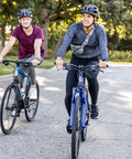 Two people riding GTX 2 Hybrid Bike For Men And Women With 700C Wheels 21 Speed Gearing Aluminum Dual Sport Frame