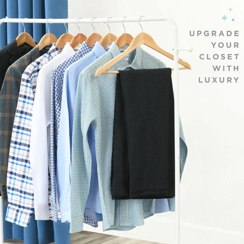 Wooden Coat Hangers 30 Pack Natural Wood Heavy Duty Non Slip For Shirts Jackets Pants Suits With Chrome Swivel Hook Premium Solid Closet Hangers For Easy Organizing, displayed with shirts and a pair of pants on a clothing rack.