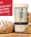Sourdough Starter Kit With Date Marked Feeding Band Thermometer Jar Scraper Cloth Cover And Metal Lid Wide Mouth Container For Easy No Fuss Feeding And Keeping Your Starter Active shown with fresh sourdough bread.