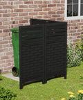Outdoor Privacy Fence Panels For Yard And Garden Keep Nosy Neighbors Out, Resin HDPE Panels To Hide Pool Equipment A C Units And Trash Cans, 4 Pack Black, shown hiding a green bin against a brick wall.