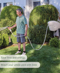 Man in garden using Beige 100 Foot Automatic Retractable Garden Hose Reel With One Half Inch UV Stabilized Kink Free Hose Wall Mounted Setup