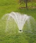 Adjustable Turret Metal Sprinkler With 8 Modes for Lawn and Yard Watering in use, spraying water on a green lawn