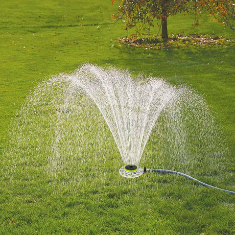 Adjustable Turret Metal Sprinkler With 8 Modes for Lawn and Yard Watering in use, spraying water on a green lawn
