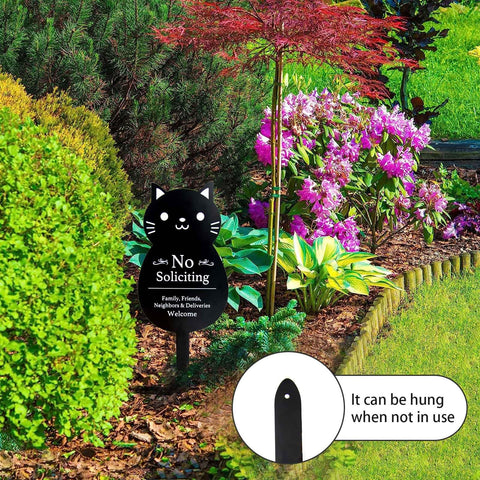 No Soliciting Sign For Home And Yard, Funny Black Cat Metal Sign, 16.5 By 7.1 Inches in garden with colorful flowers