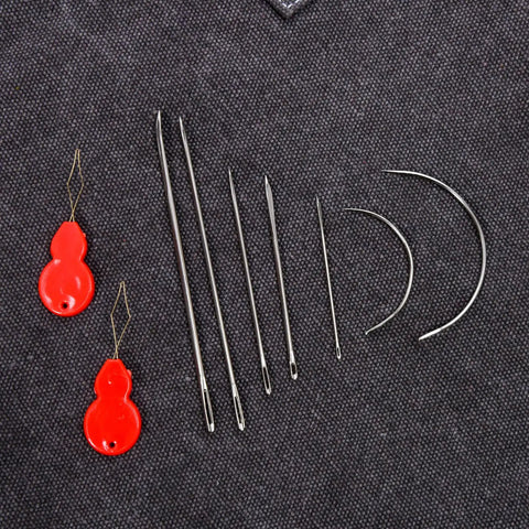 Beefed Up Hand Sewing Needles Kit 14 Piece Set With 10 Leather Needles And 4 Curved Needles on fabric background.