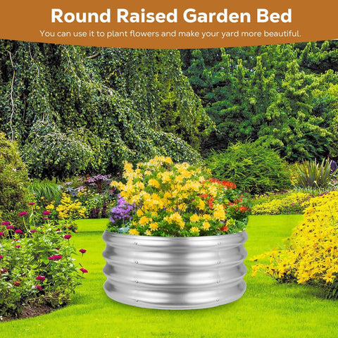 Floral display in round raised garden bed with silver finish in lush green garden setting
