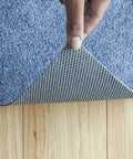 Person lifting corner of Ultra Slim Non Slip Rug Pad 2x3 Ft Felt And Rubber One Sixteenth Inch Thick For High Traffic Areas And Entryways