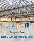 Spacious warehouse illuminated by 150W LED High Bay Light UFO Style 22500 Lumens 5000K with industrial ceiling setup.