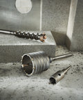 2-5/8 Inch Two Piece Rotary Hammer Core Bit with Wave Design and Asymmetrical Carbide Teeth on concrete background