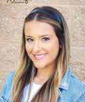 One Inch Vegan Leather Headband For Women Non Slip Hair Band Black worn by woman with long hair, styled casually and smiling.
