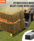 Tractor lifting hay bale using Workhorse Clamp On Pallet Forks For Tractors And Skid Steers, 2000 Lbs Capacity, 43 Inch Total Length