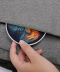 Person placing 10W Fast Wireless Charger Pad For Travel And Home Office Slim Portable Qi Charging Mat into a gray bag pocket.