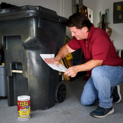 Man applying Thick Rubberized Waterproof Tape That Seals Leaks Fast And Holds Up Under Water Flexible Patch on trash can