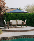Outdoor setup featuring a cantilever umbrella with Heavy Duty Offset Umbrella Base Weight Set For Cantilever Umbrellas Fill With Water Or Sand.
