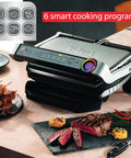 T-Fal OptiGrill Indoor Panini Press With Smart Sensor Tech, Six Auto Cooking Programs For Perfect Thicker Cuts displayed with grilled steaks.
