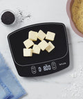 Waterproof Digital Kitchen Scale with 11 Pound Capacity Pro Grade Precision Ultra Accurate To 0.01 Oz And 1 Gram Tare Function Easy Clean Stainless Platform Ideal For Baking Cooking And Liquid Measurements displaying butter cubes