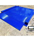 Heavy Duty Low Profile Drum Scale Built Tough With Smooth Hinged Ramps For No Sweat Barrel Rolling And Rock Solid Weighing Capability Up To 5000 Pounds With Spot On One Pound Accuracy NTEP Approved, blue steel platform with display.