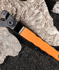 Universal Adjustable Pin Wrench For Angle Grinders And Power Tools With No Hassle Twist Knob Adjustment Heavy Duty Carbon Steel Spanner on rocks