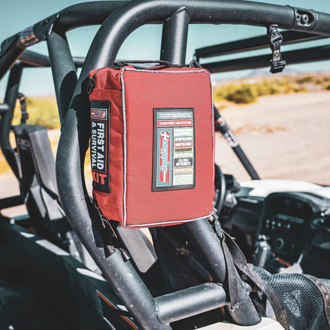 Red RapidCare first aid kit mounted on off-road vehicle roll cage for outdoor emergency use
